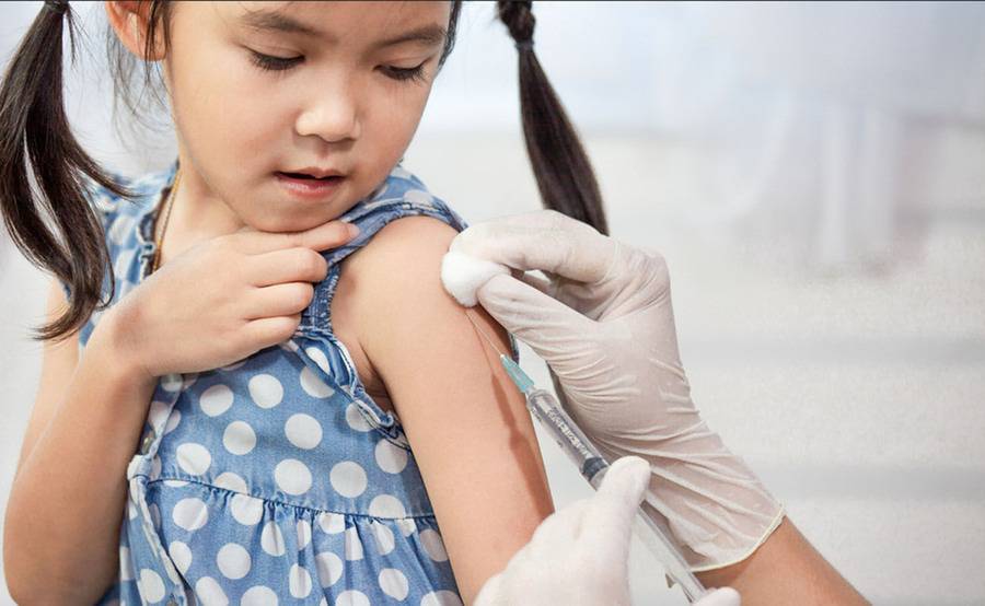 A girl gets vaccinated at doctor's office.
