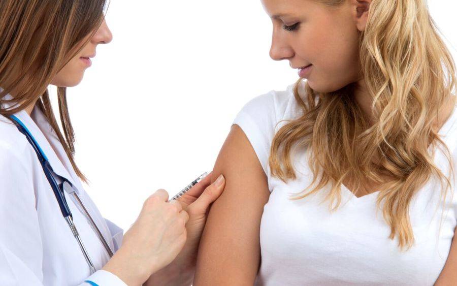 Provider gives woman flu shot.