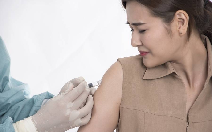 Patient receiving flu vaccination shot