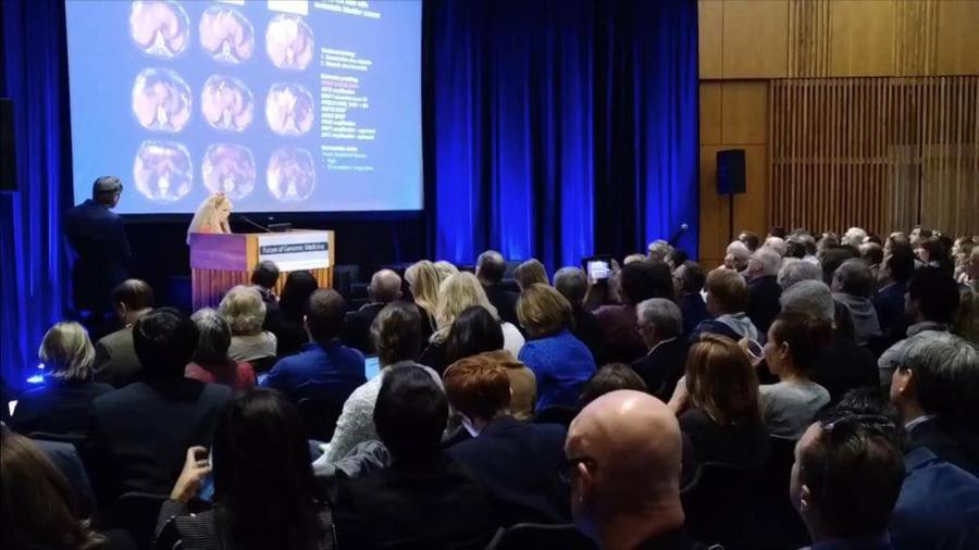 A group of attendees view a presentation at the 10th Annual Genomic Medicine Conference, which garnered media coverage,