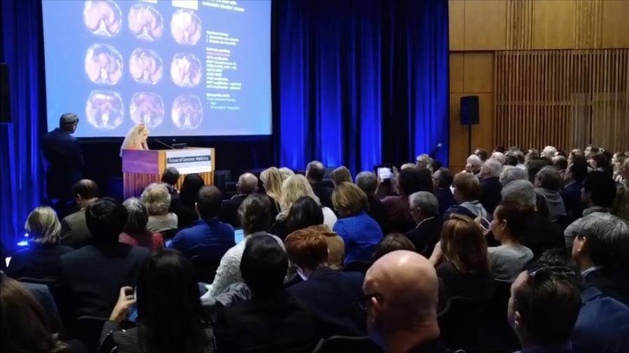 A group of attendees view a presentation at the 10th Annual Genomic Medicine Conference, which garnered media coverage, 