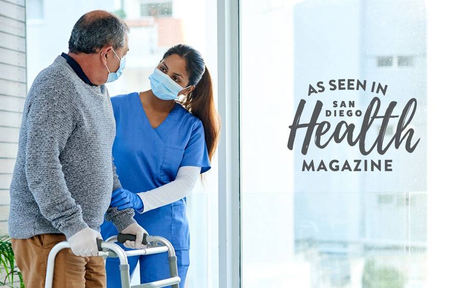 An emergency department nurse helps an older man as he uses a walker - SD Health Magazine