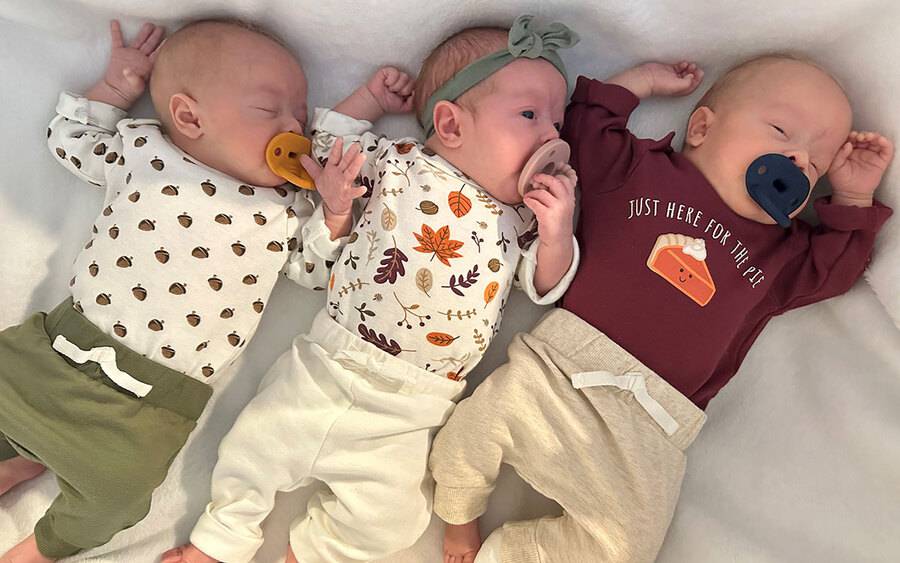 The Gibson triplets (from left): Axton, Ansley and Asher laying down on a blanket.