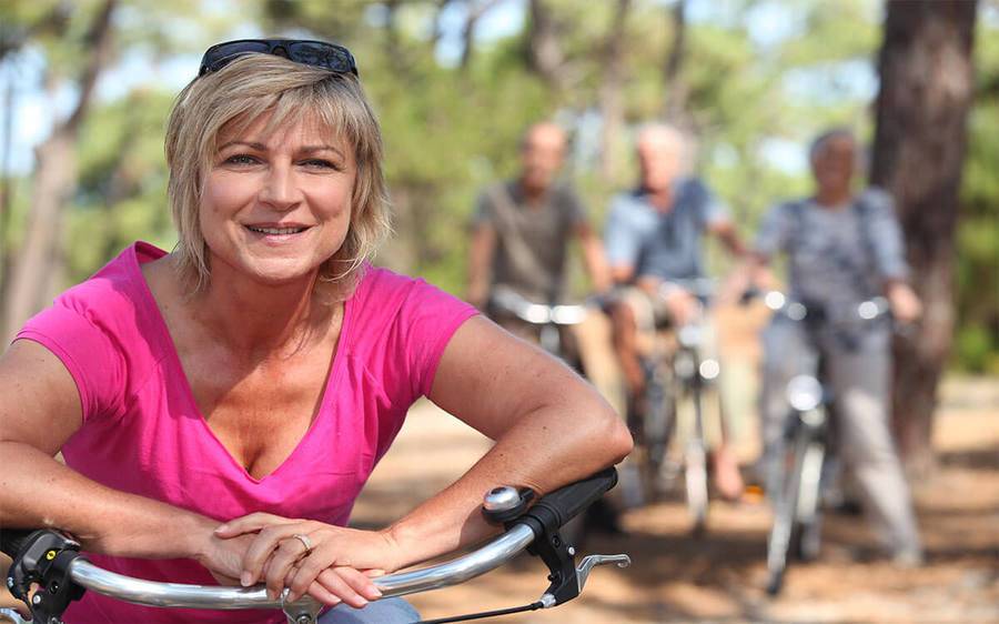 Active middle aged woman on bike