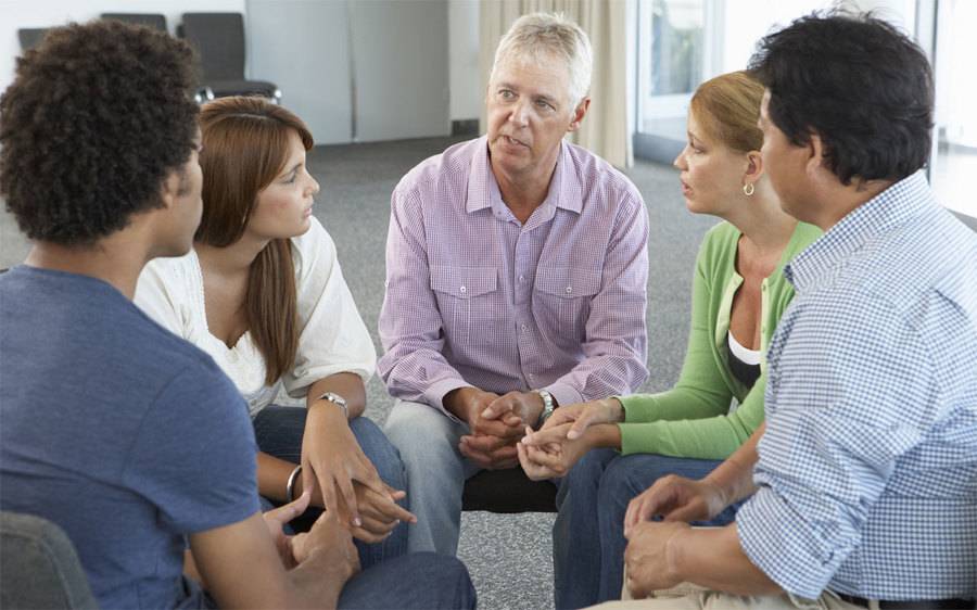 Diverse support group sitting in a circle
