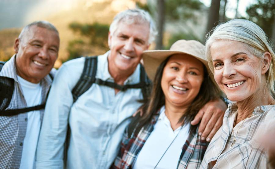 A diverse group of friends hiking, illustrating the quality of life after a hip replacement.