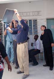 Doctor volunteer reading a patients film in Haiti