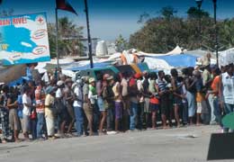 Haiti residents lined up in water line.