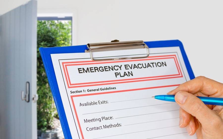 Home owner handwrites emergency evacuation plan.