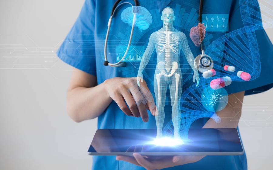 A health care provider holds a mobile tablet and views 3D images of a human body, a DNA sequence, pills and graphical data.