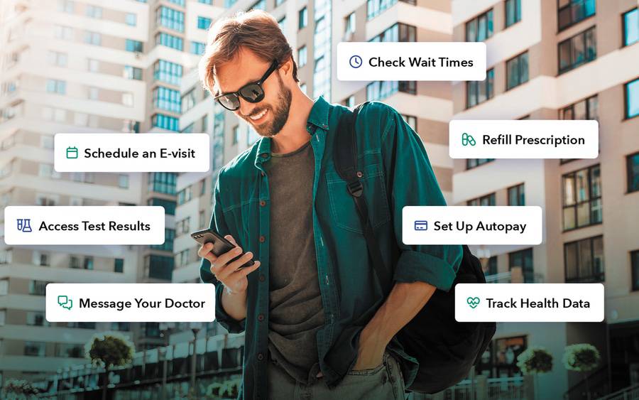 A young man stands outdoors as he accesses his MyScripps health portal on his mobile phone.
