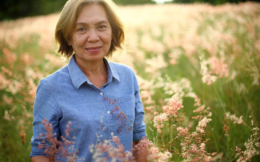 Woman standing in field of flowers