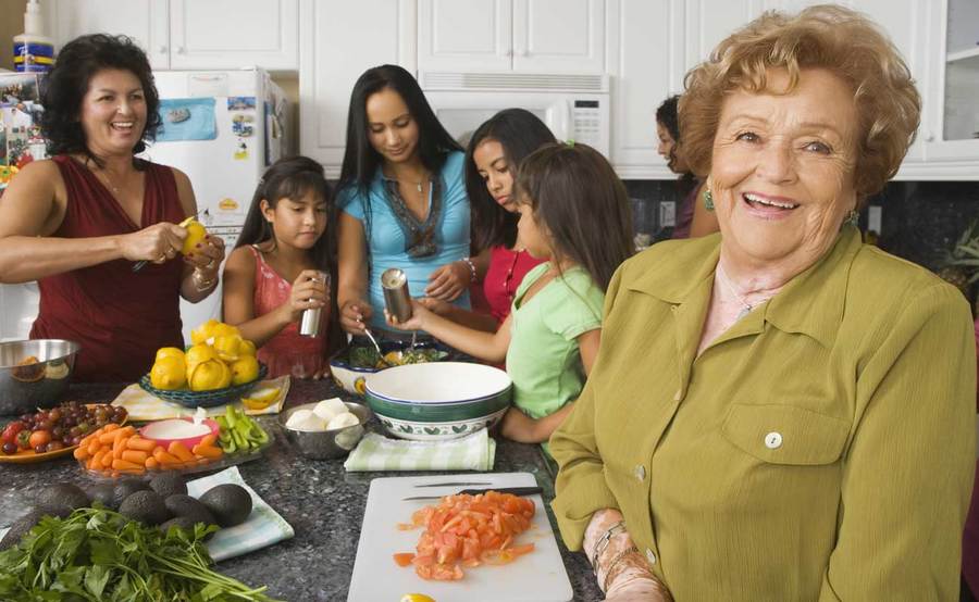 Mature woman happy and cooking with family