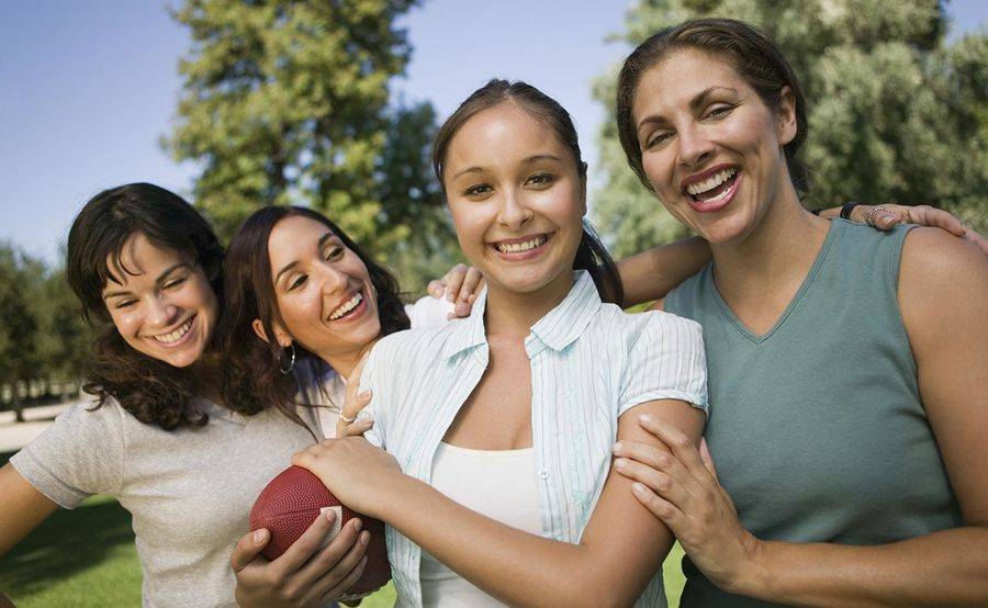 Young adult women playing at park