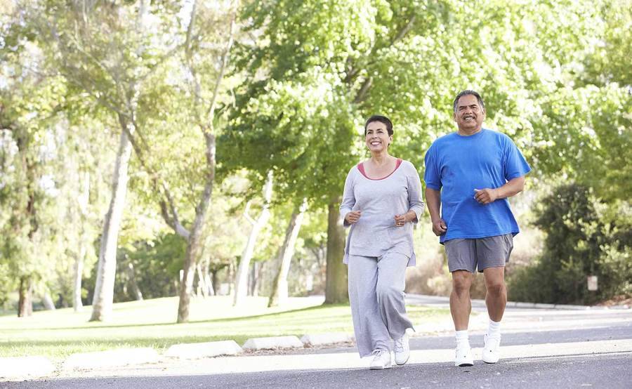 Mature couple exercising in park