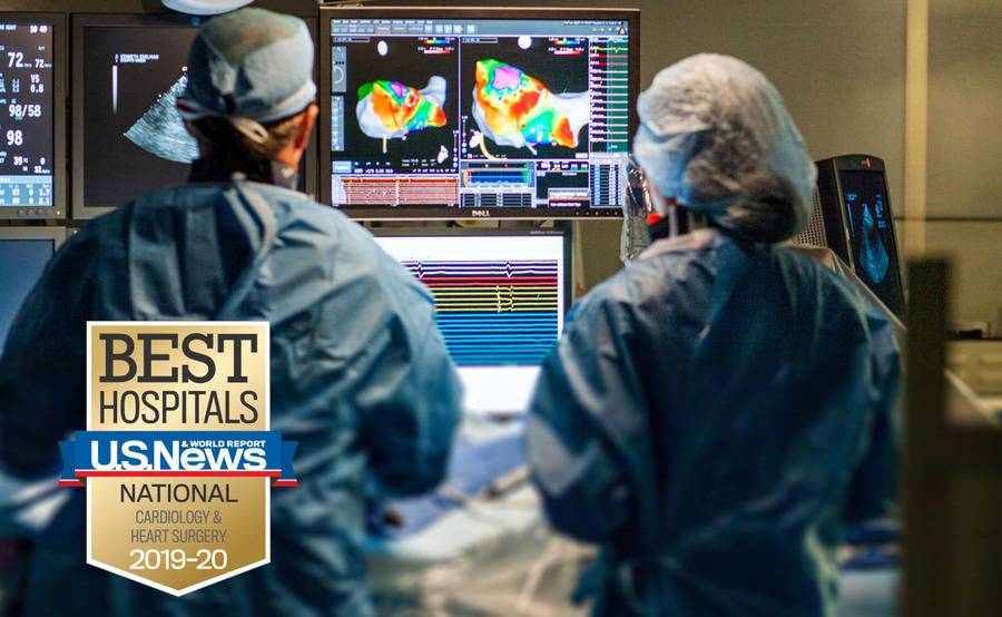 Two Scripps electrophysiologists study an image during an arrhythmia procedure.