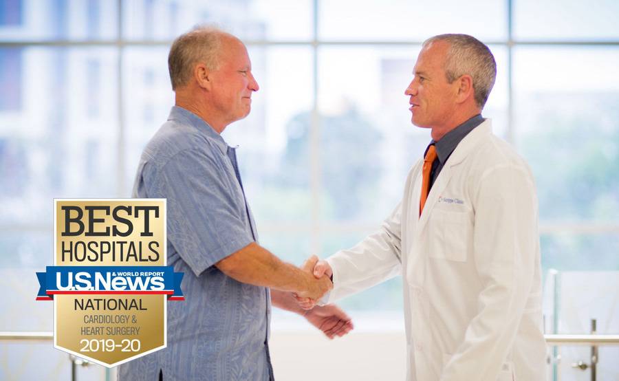 Scripps Clinic cardiologist Douglas Gibson, MD, and a patient shake hands while discussing heart care.