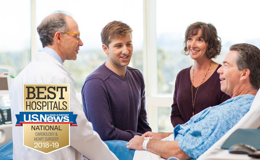 Cardiologist Martin Charlat, MD, discusses heart care with a patient and his family members.