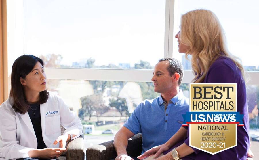 Dr. Kiyon Chung sits with a man and a woman in a bright, sunny room.