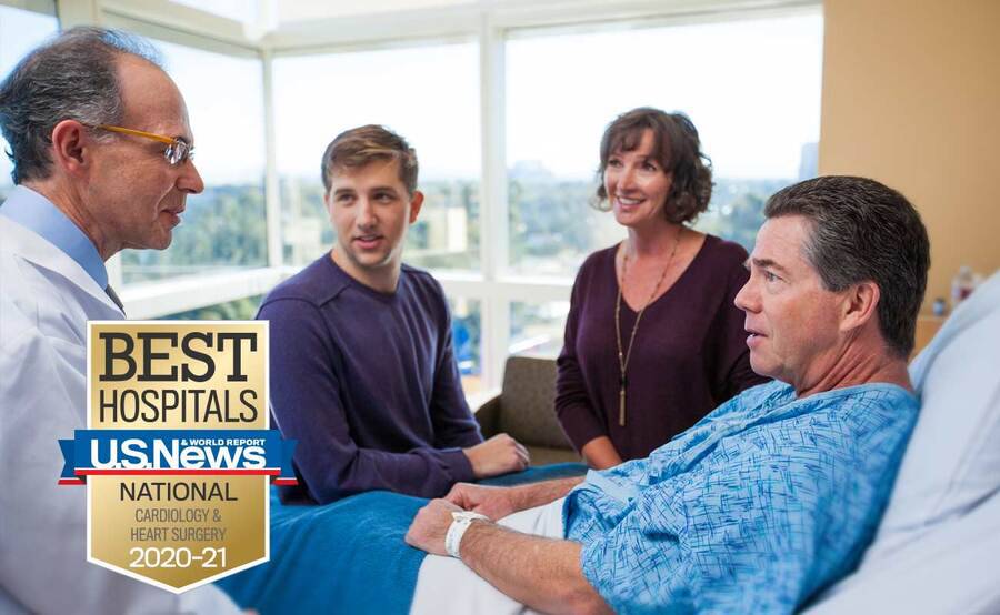Cardiologist Martin Charlat, MD, discusses heart care with a patient and his family members.