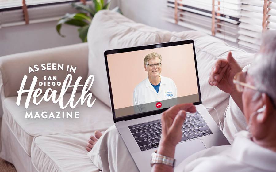 An older man sitting on his couch talks to his Scripps cardiologist, Dr. Thomas Heywood, via a convenient video visit on his laptop computer.