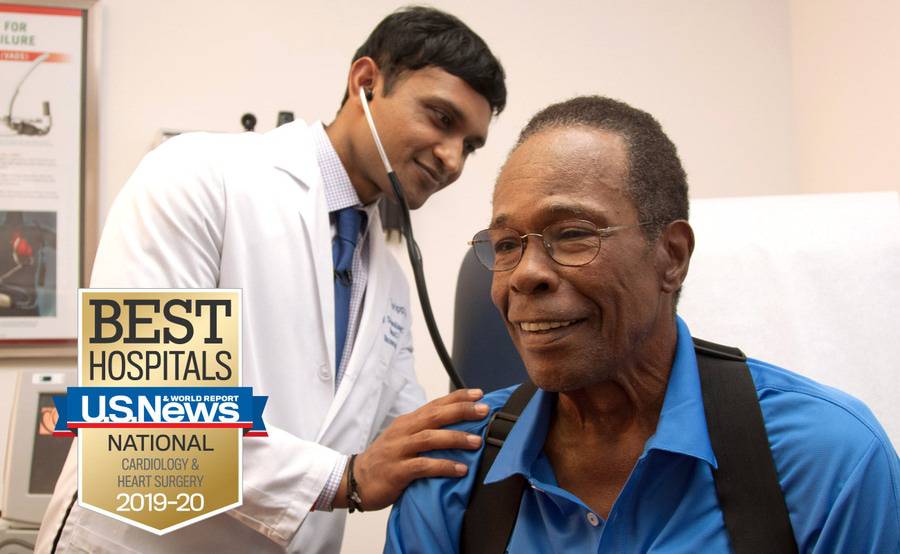 Scripps Clinic cardiologist Ajay Srivastava, MD, uses a stethoscope during a heart examination with Hall of Famer Rod Carew.