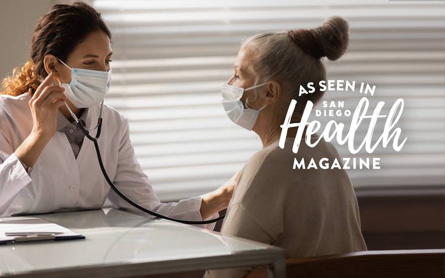 A cardiologist listens to the heart of a woman patient through a stethoscope - SD Health Magazine