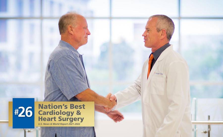 Scripps Clinic cardiologist Douglas Gibson, MD, and a patient shake hands while discussing heart care.