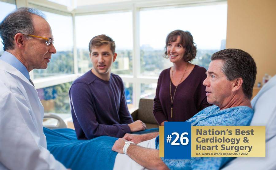 Cardiologist Martin Charlat, MD, discusses heart care with a patient and his family members.