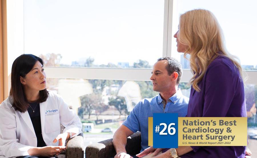 Dr. Kiyon Chung sits with a man and a woman in a bright, sunny room.