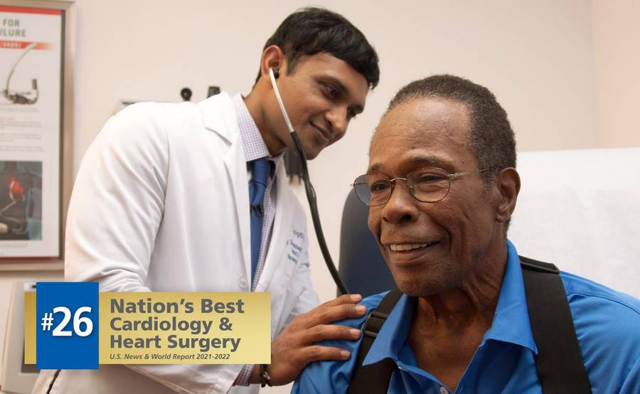 Scripps Clinic cardiologist Ajay Srivastava, MD, uses a stethoscope during a heart examination with Hall of Famer Rod Carew.