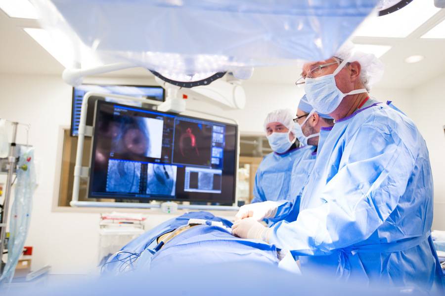 Scripps cardiothoracic surgeon Scot Brewster, MD, and colleagues review a heart attack patient's imaging results.