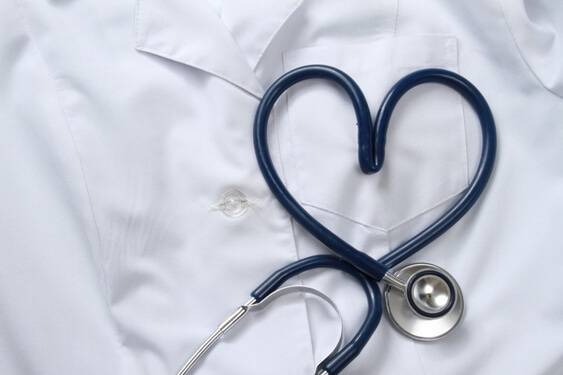 A stethoscope in the shape of a heart lays on a doctor's coat as part of a discussion on heart disease and diabetes.