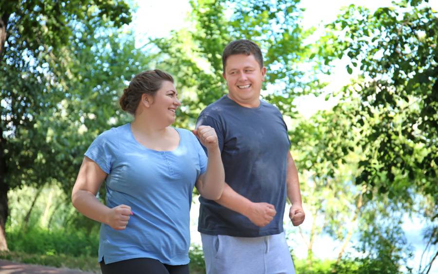 Two friends work out together,  helping each other on their weight-loss journey.