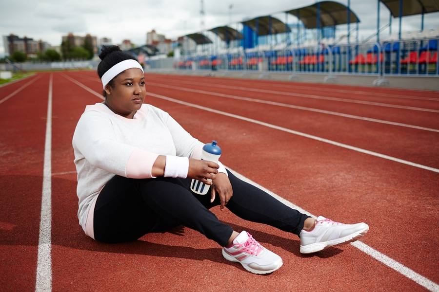 After gastric sleeve surgery recovery, a heavyset woman does light exercising.