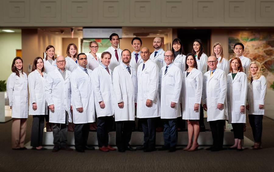 Standing in two rows and wearing white lab coats, the faculty and fellows of the Hematology and Medical Oncology Fellowship Program at Scripps Clinic are shaping the future of cancer treatment.