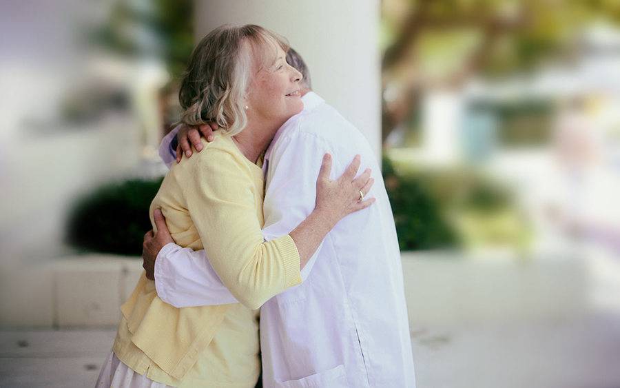 A doctor and patient embrace to signify the importance of National Doctors Day.