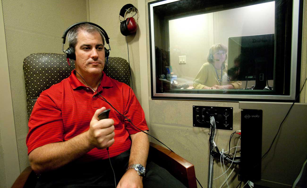 Man wearing headphones undergoes a hearing test.