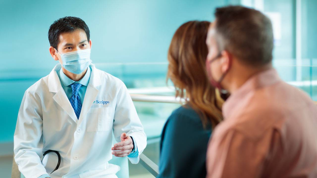 Dr. Chung speaks with two patients. 