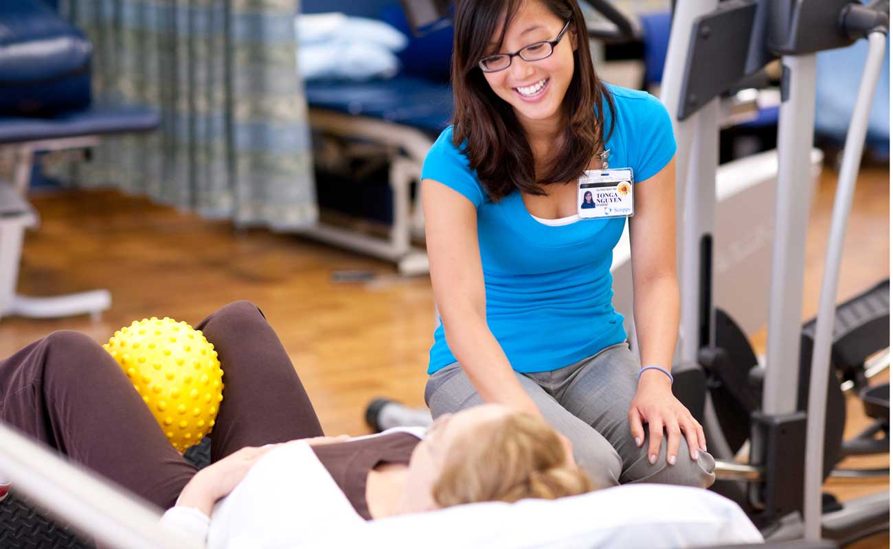 Scripps pelvic floor physical rehabilitation therapist assists a patient in a therapy treatment.