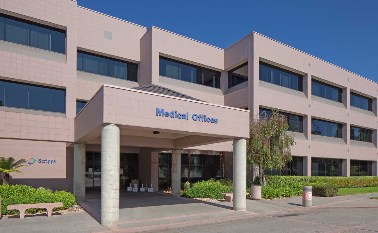 The exterior of Scripps Clinic Del Mar, located inside a three-story medical building on the corner of El Camino Real and High Bluff Drive in San Diego.