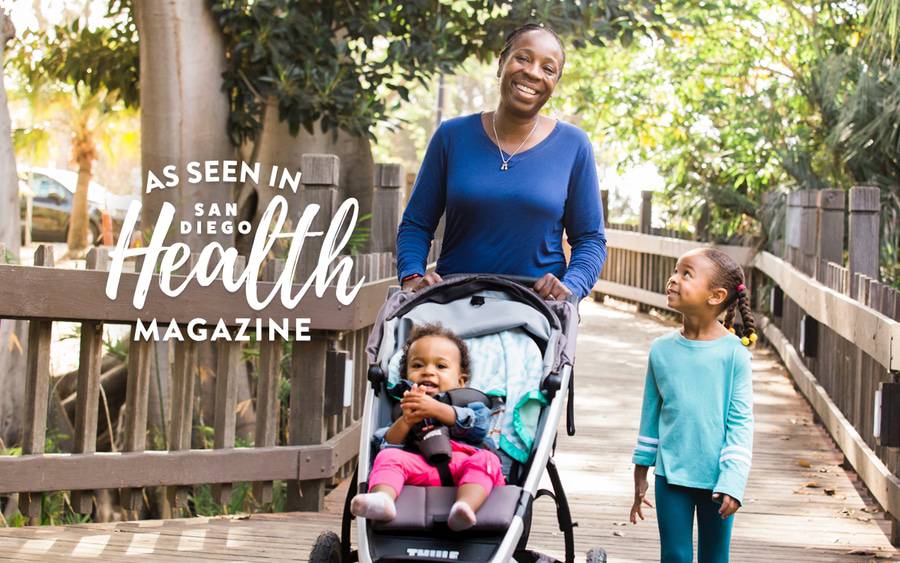 Toluwalase Ajayi, MD, a palliative care physician, walks with her two young daughters, one in a stroller, as she balances a busy home and work life while leading the San Diego County Medical Society.