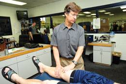 Team physician Heinz Hoenecke, MD, examines a player during spring training.