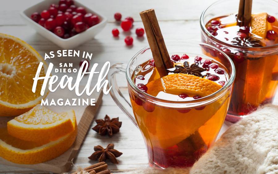 A healthy holiday tea is pictured with cinnamon, nutmeg, oranges and pomegranates.  SD Health Magazine