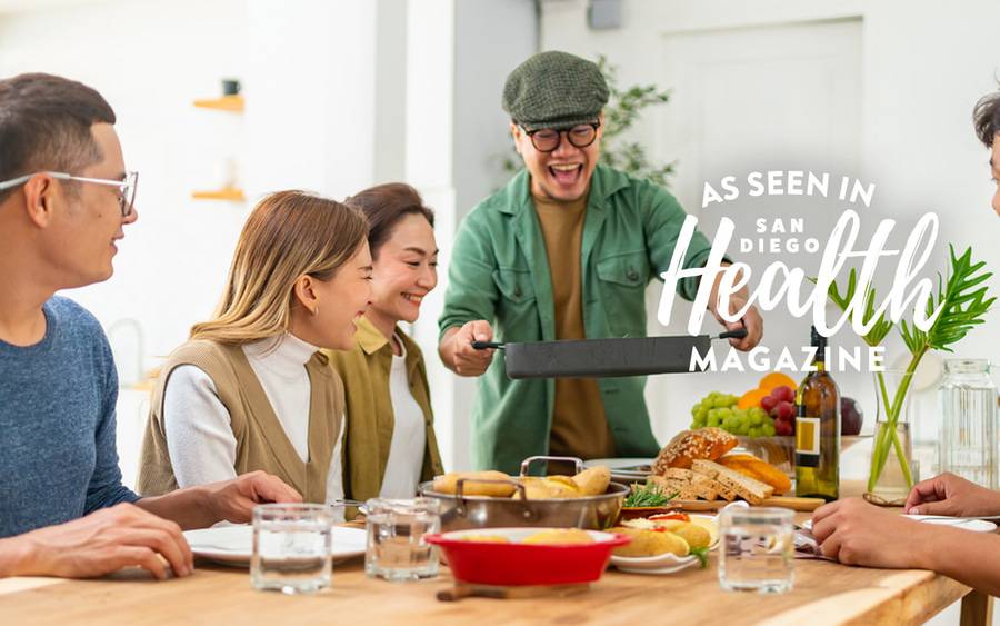 An Asian family sits down for a Thanksgiving meal including potatoes, bread and fruit. San Diego Health Magazine