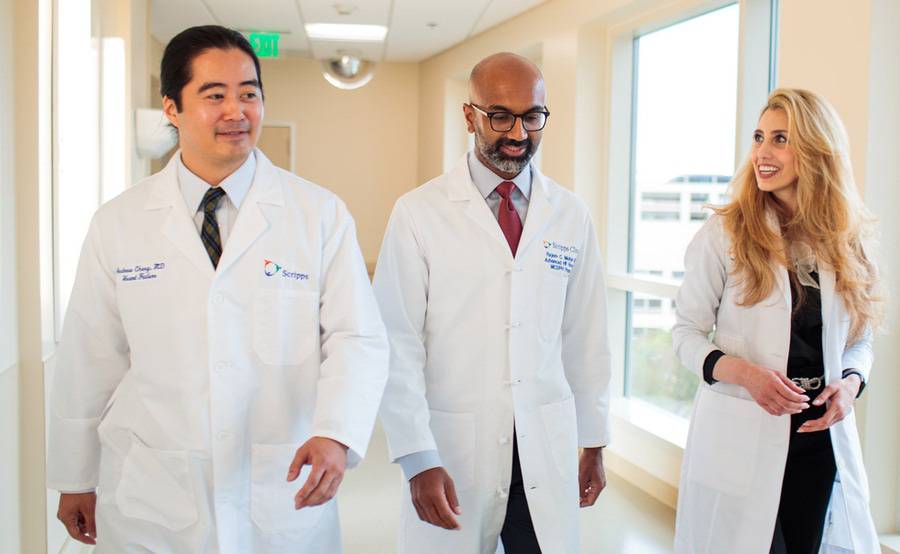 Drs. Andrew Cheng, Rajeev Mohan and Rola Khedraki walk alongside each other.