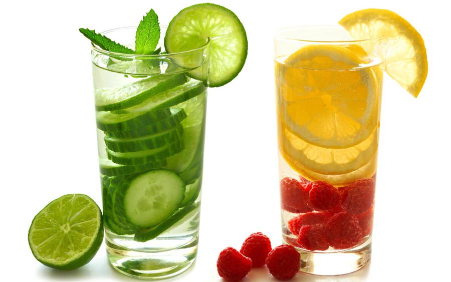A glass of water with cucumber slices and a glass of water with lemon and raspberry represent the easy ways to enjoy flavored water to help prevent dehydration.