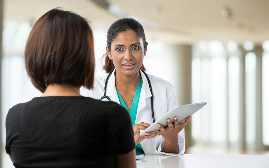 New patient asks questions to new primary care physician during first visit.