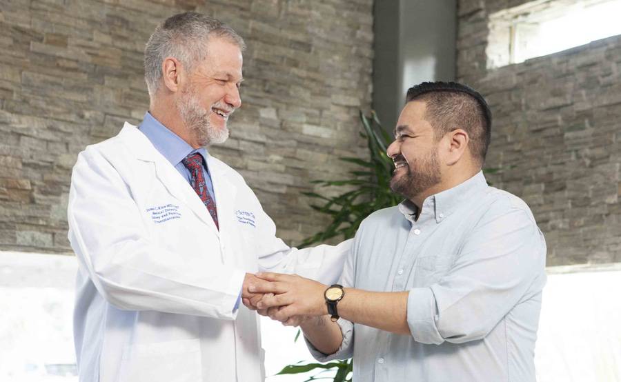 Dr. James Rice, Transplantation Nephrology, Scripps Clinic and kidney transplant patient Juan Ramos shaking hands,