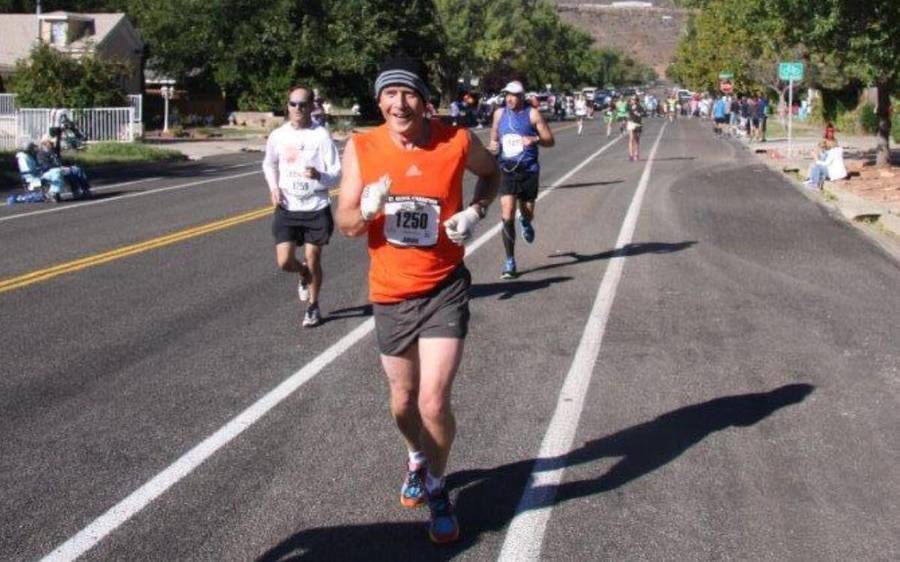 Scripps employee, Johan Otter, jogs along a bike lane with other racers at the Boston Marathon.